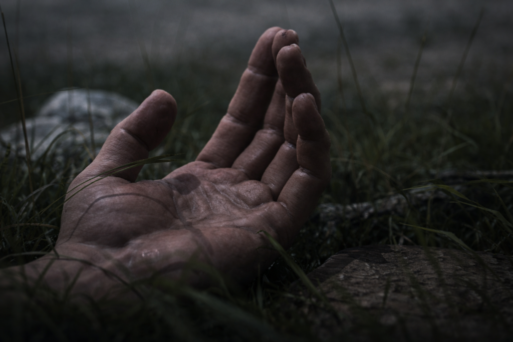 CGI close-up of a human hand resting on a dark surface with soft lighting.